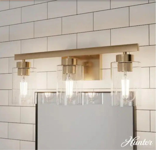 Hunter Hartland 22 in. 3-Light Alturas Gold Vanity Light with Clear Seeded Glass